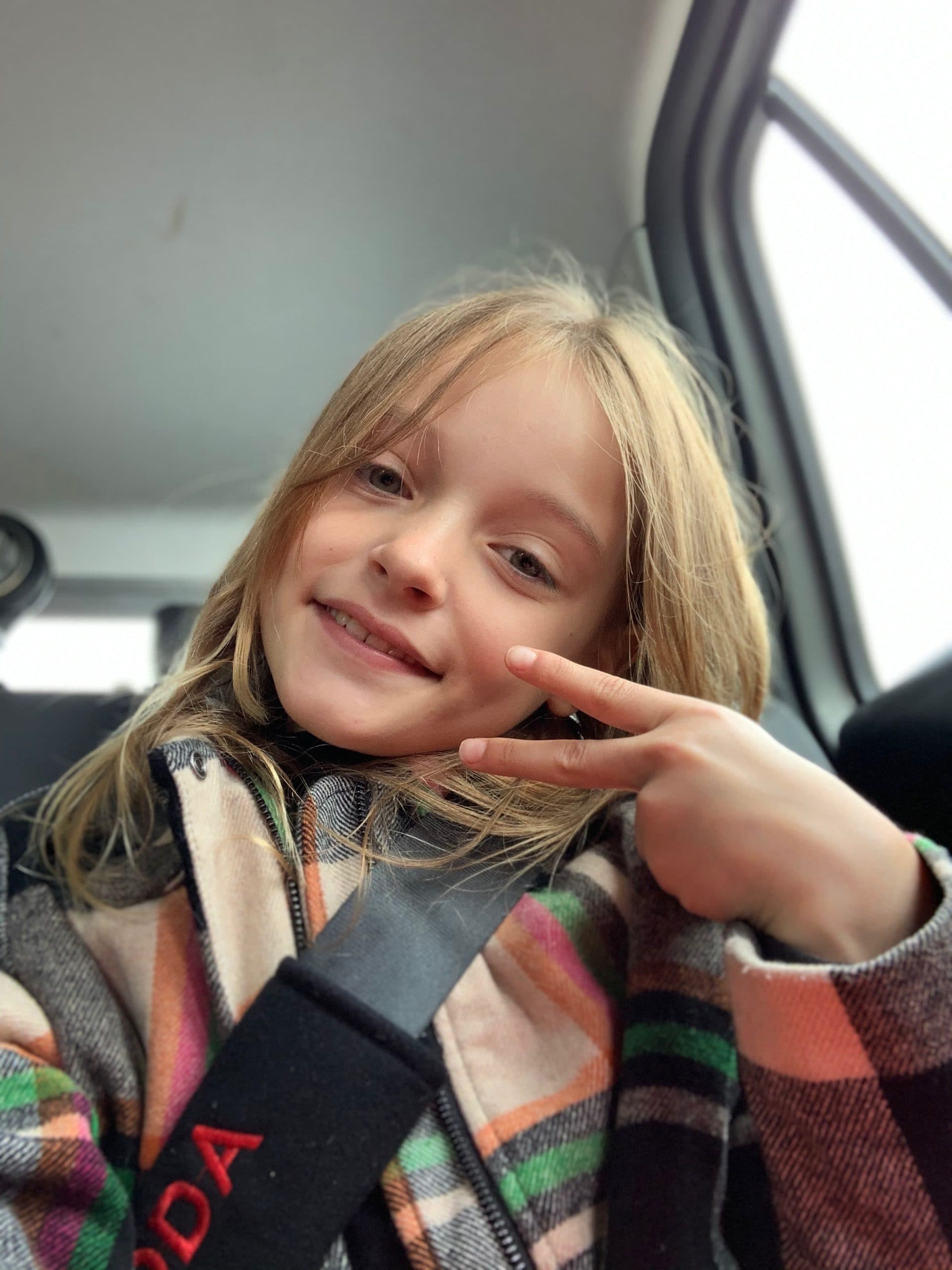 Penelope smilende i bilen på vej ud